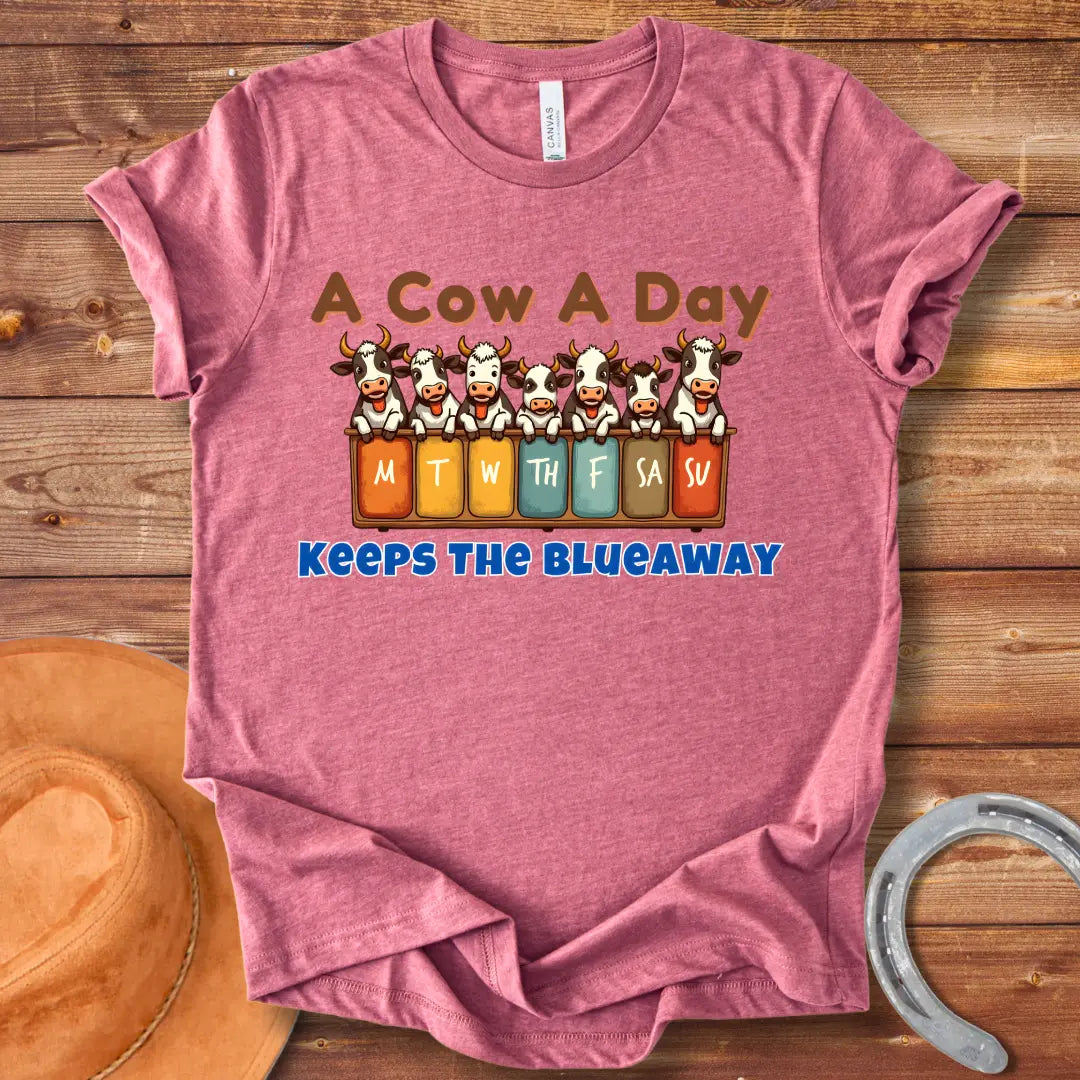 Illustration of seven happy cows each peeking over a box holding days of the week, the text at the bottom saying 'Keeps the Blue Away'.