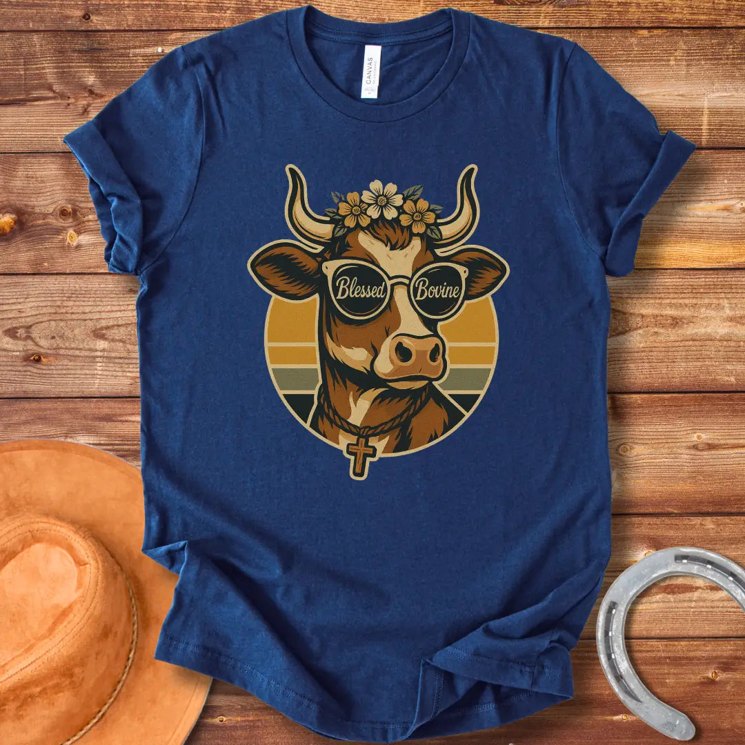 Blessed Bovine T-shirt design featuring a cow wearing sunglasses that say blessed bovine with a floral crown and a rosary.