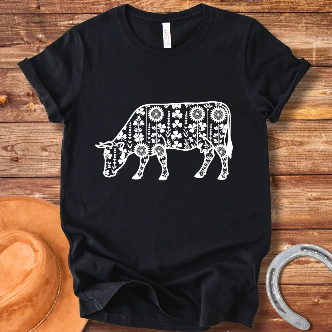 Detailed line art of a cow grazing, filled with floral patterns including sunflowers and shamrocks, perfect for cow lovers.
