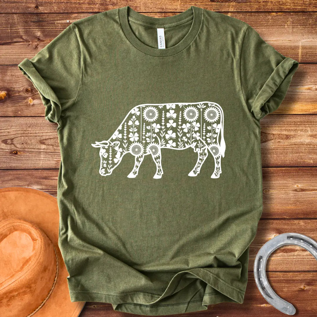 Detailed line art of a cow grazing, filled with floral patterns including sunflowers and shamrocks, perfect for cow lovers.