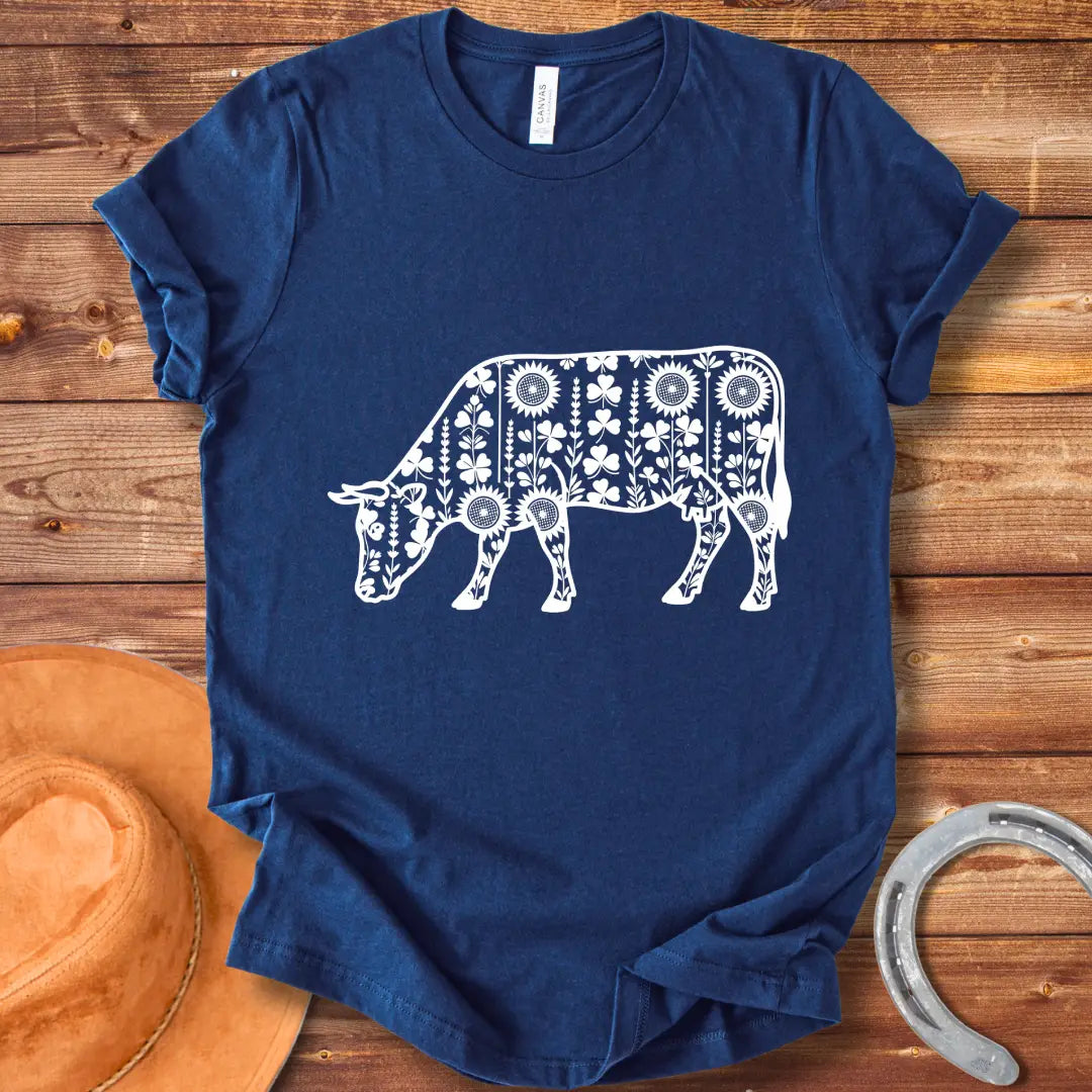 Detailed line art of a cow grazing, filled with floral patterns including sunflowers and shamrocks, perfect for cow lovers.