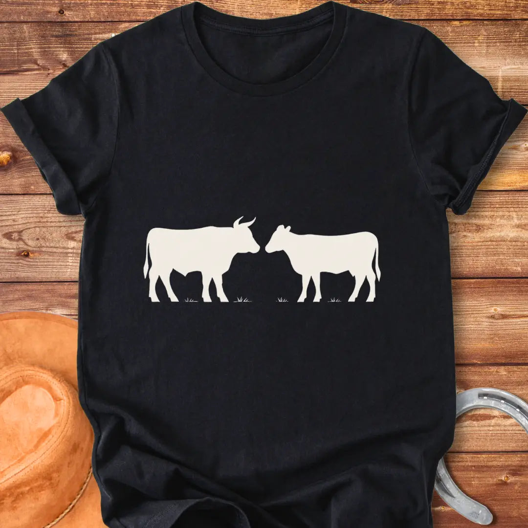 Silhouette of a bull and a heifer facing each other, representing a standoff on a t-shirt design.