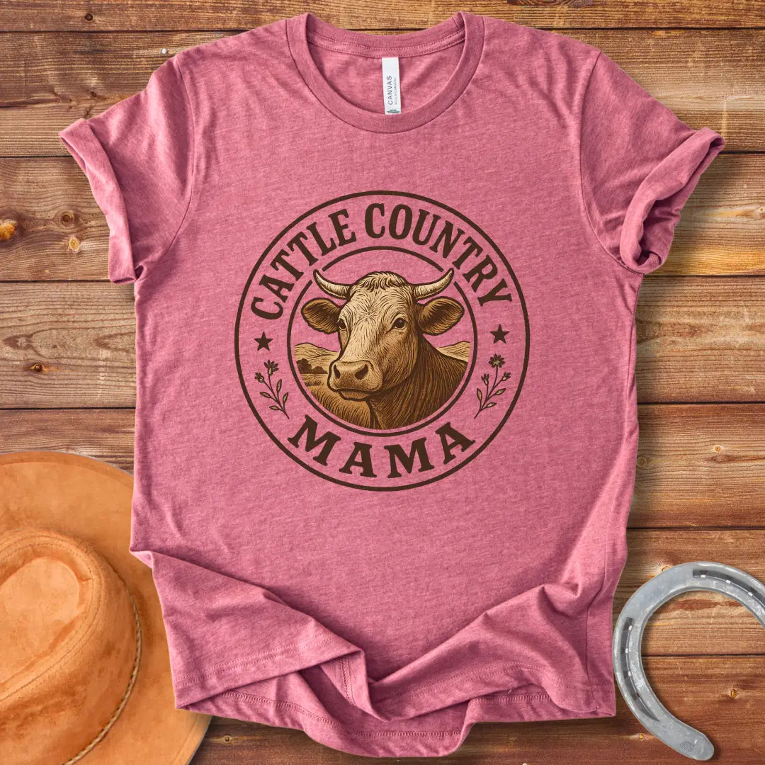 A sepia-toned illustration of a cow's head, surrounded by a circular design that reads 'Cattle Country Mama'.