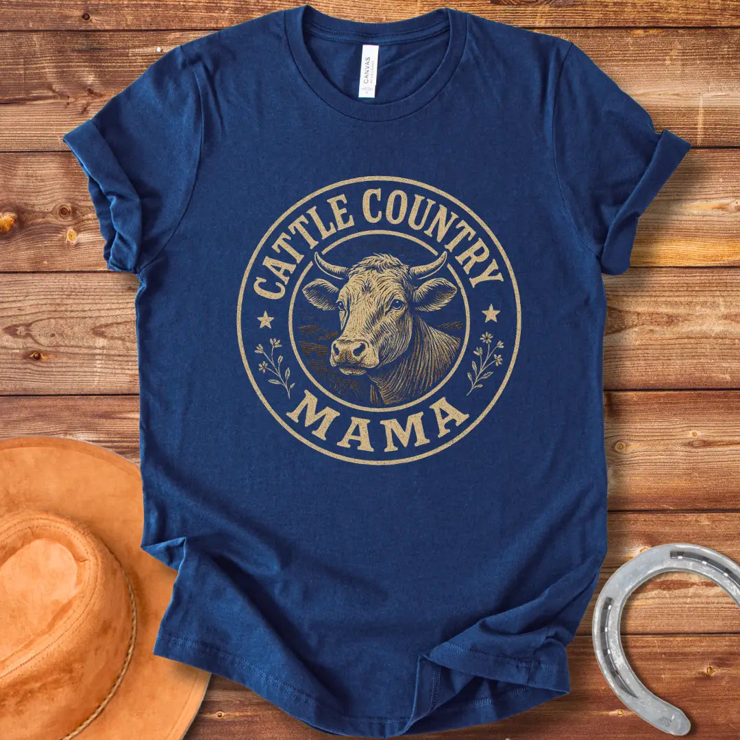 A sepia-toned illustration of a cow's head, surrounded by a circular design that reads 'Cattle Country Mama'.