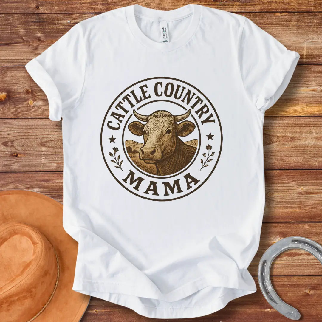 A sepia-toned illustration of a cow's head, surrounded by a circular design that reads 'Cattle Country Mama'.