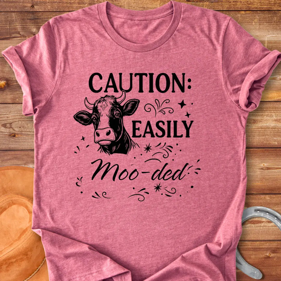 Caution: Moo-ded T-shirt featuring a detailed cow illustration with decorative elements.