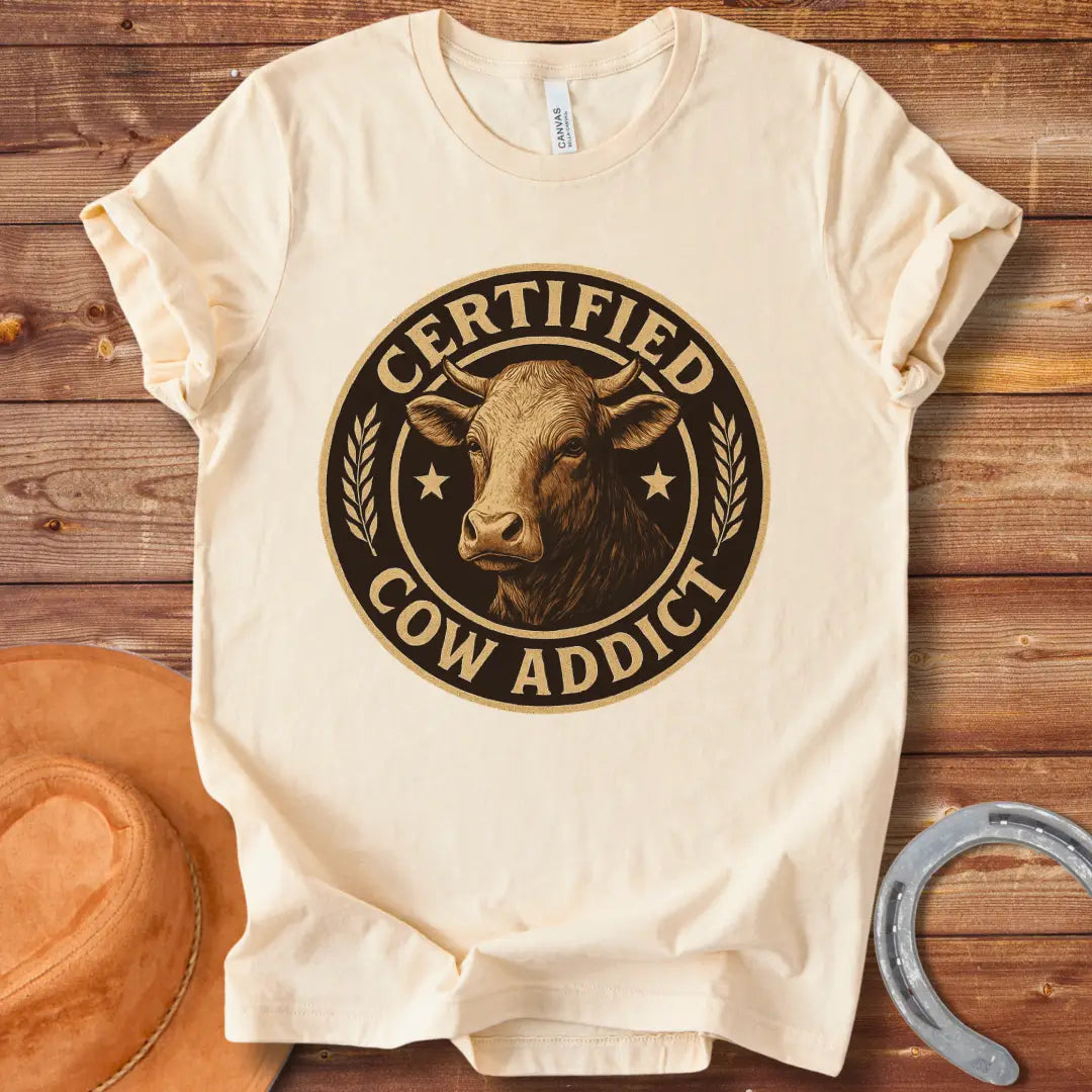 Certified Cow Addict T-Shirt design featuring a detailed cow portrait inside a circular badge.