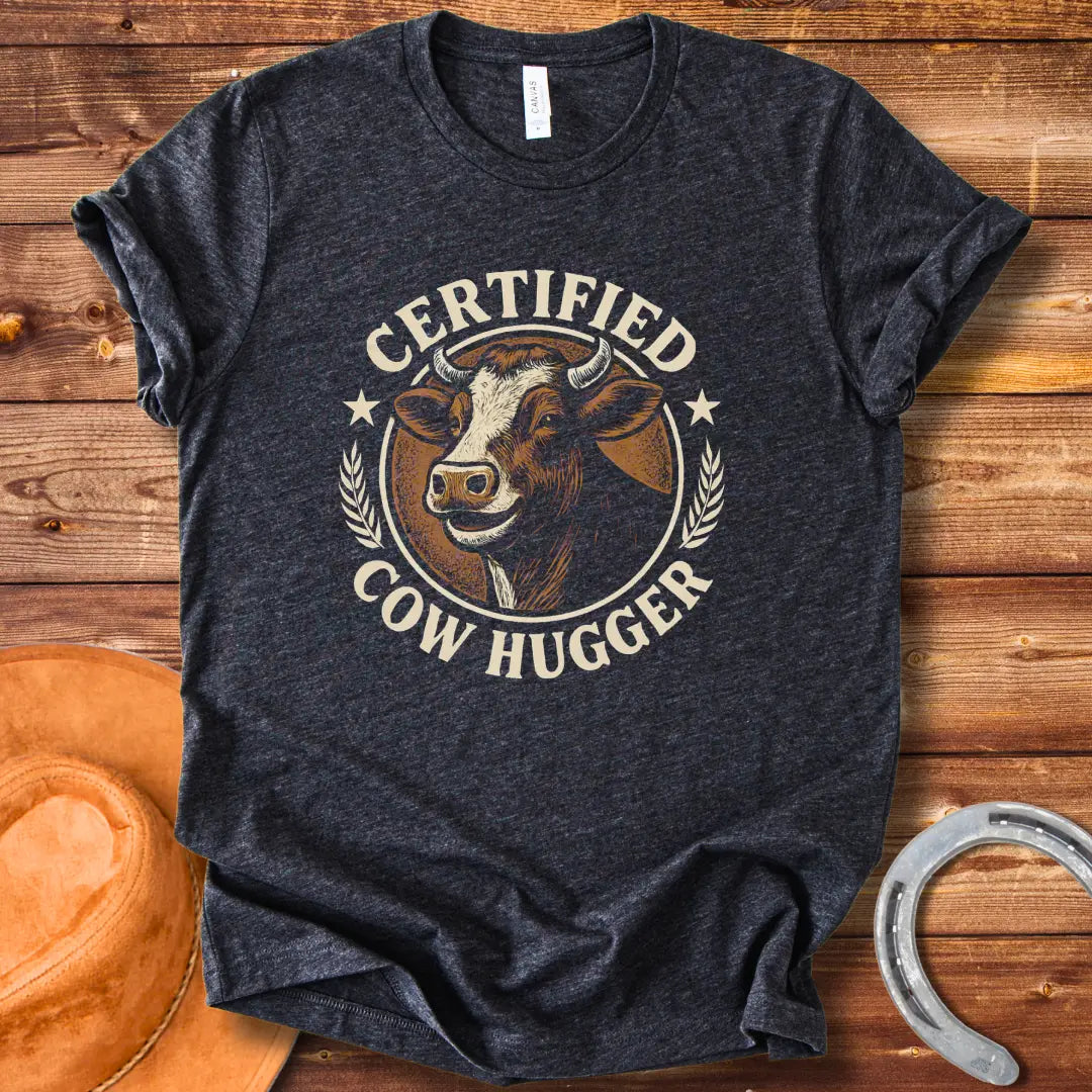 Certified Cow Hugger T-Shirt featuring a smiling cow illustration inside a circular emblem.