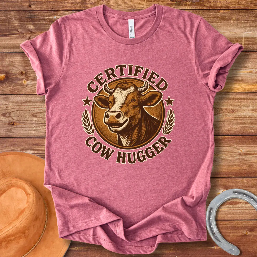 Certified Cow Hugger T-Shirt featuring a smiling cow illustration inside a circular emblem.