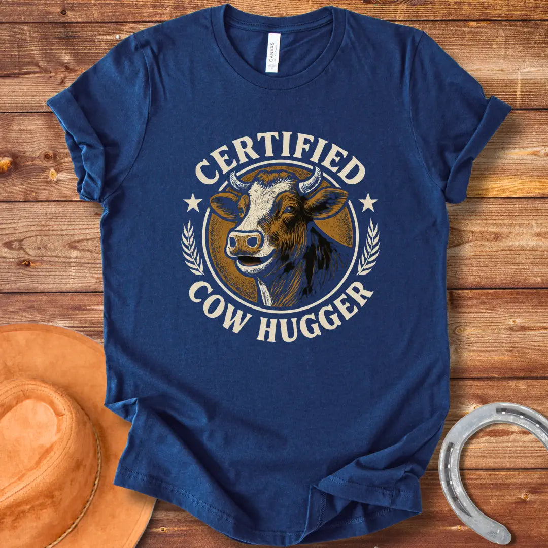 Certified Cow Hugger T-Shirt featuring a smiling cow illustration inside a circular emblem.
