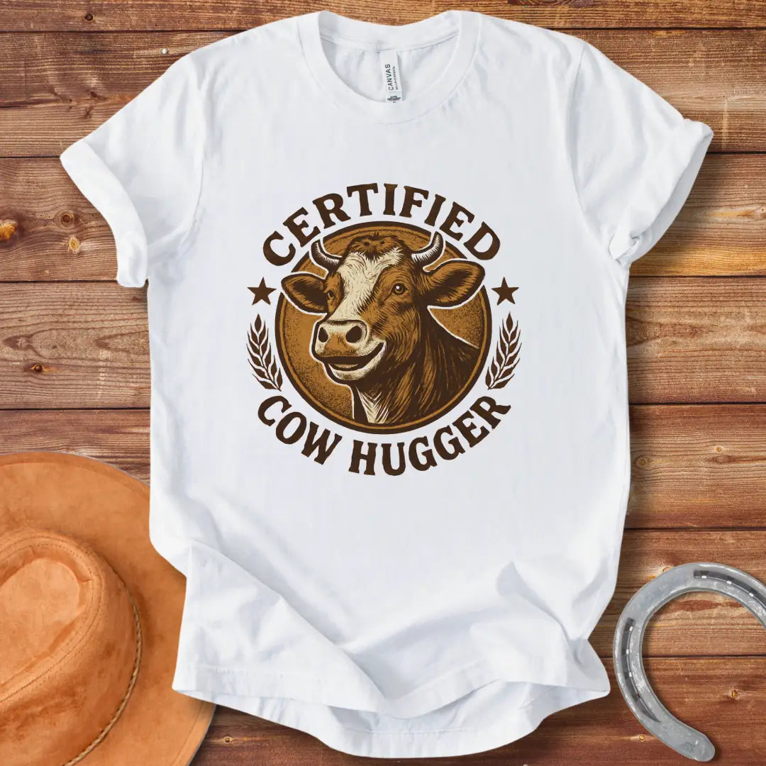 Certified Cow Hugger T-Shirt featuring a smiling cow illustration inside a circular emblem.