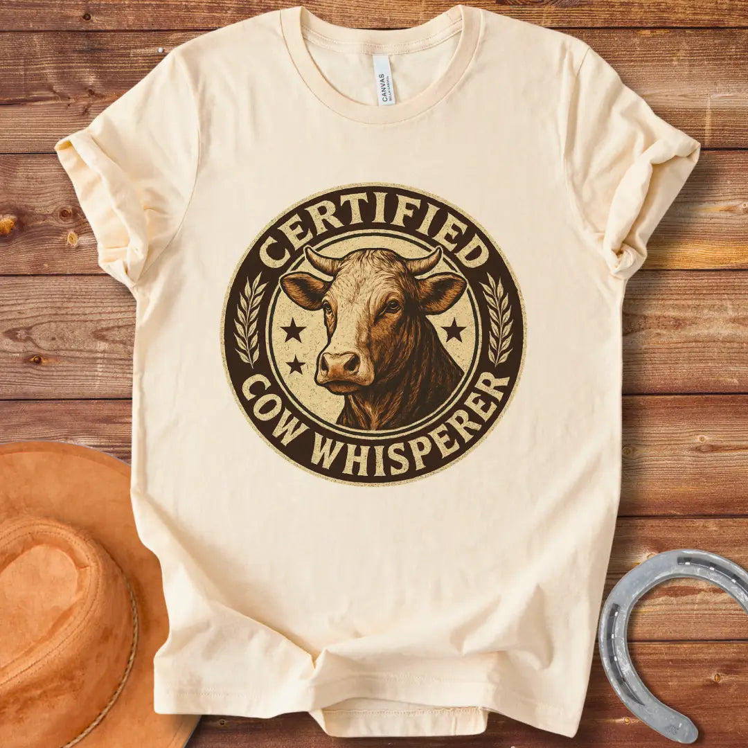 Certified Cow Whisperer T-Shirt design featuring a detailed cow face within a circular badge.