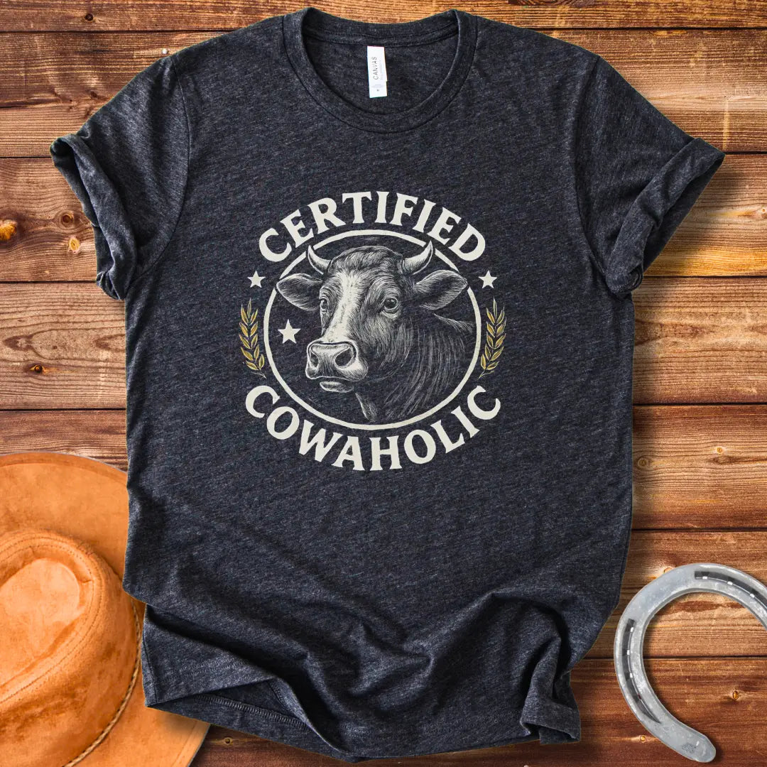 Certified Cowaholic T-shirt design featuring a cow's head in a circular badge, surrounded by text and wheat stalks.