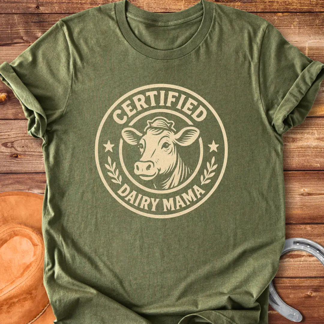 Certified Dairy Mama t-shirt design featuring a cow with a crown inside a circular logo.