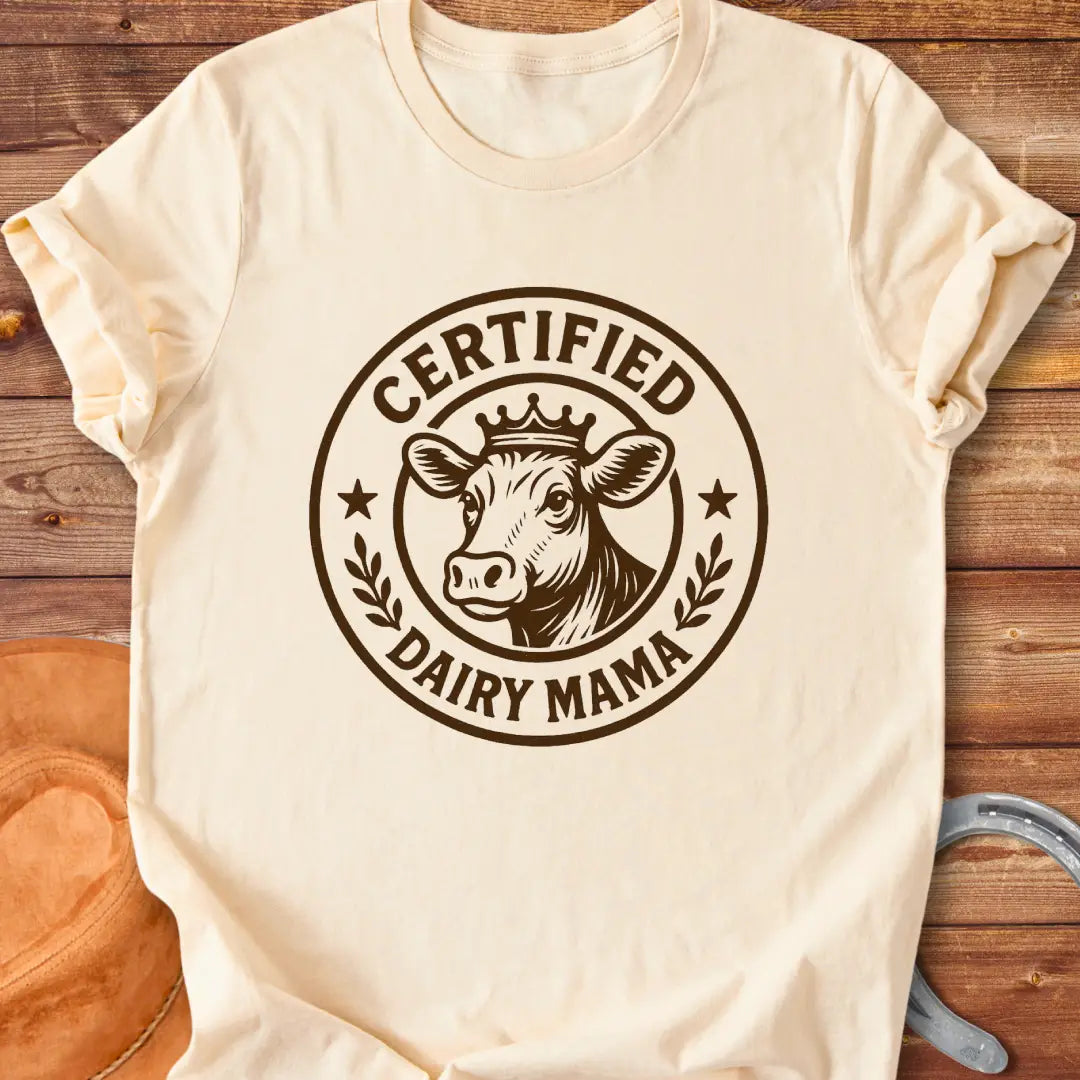 Certified Dairy Mama t-shirt design featuring a cow with a crown inside a circular logo.