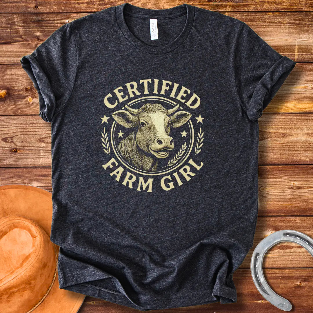 Certified Farm Girl T-Shirt design featuring a smiling cow's face inside a circular emblem with stars and wheat, perfect for cow lovers.