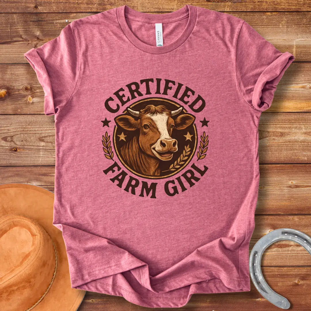 Certified Farm Girl T-Shirt design featuring a smiling cow's face inside a circular emblem with stars and wheat, perfect for cow lovers.