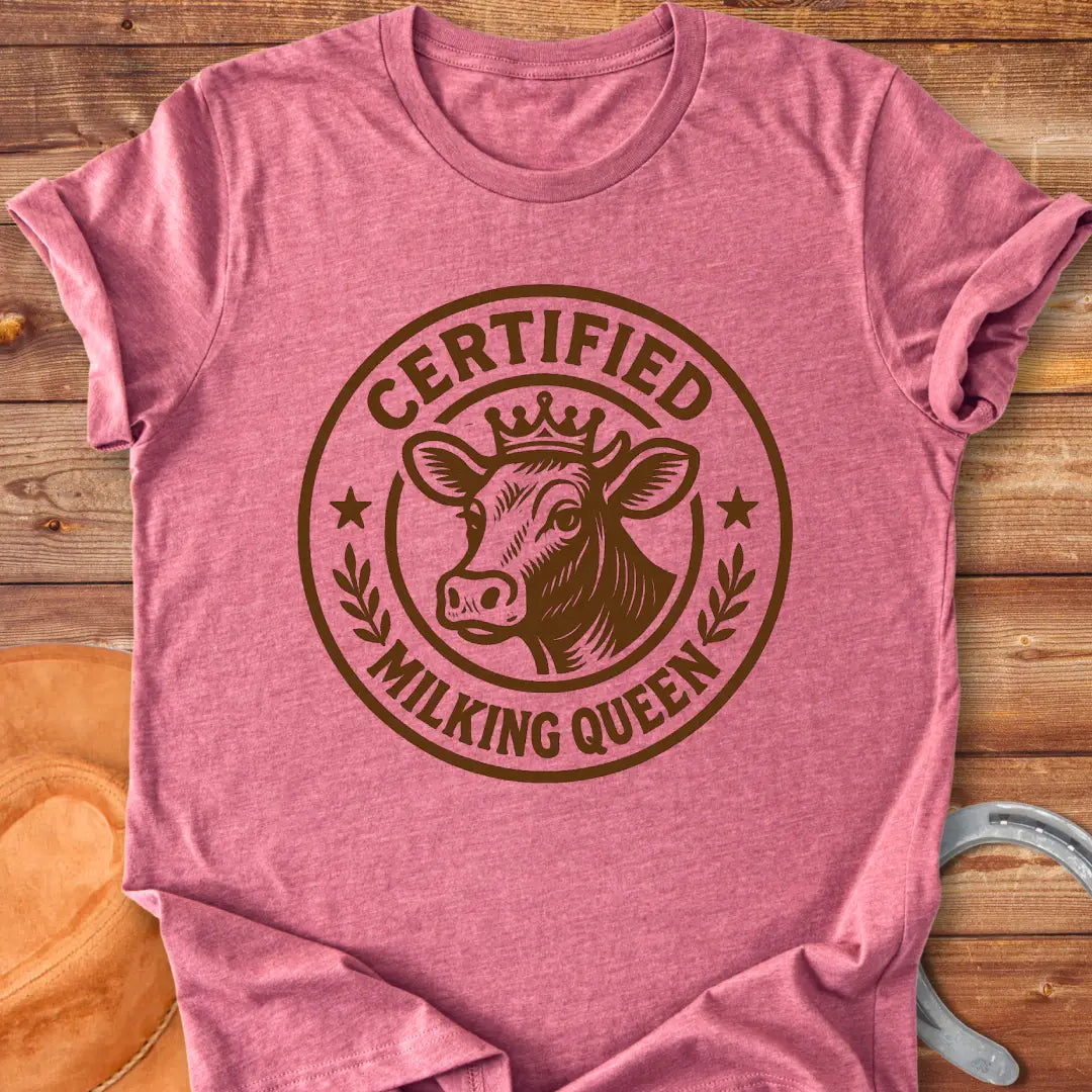 Certified Milking Queen T-Shirt design with a cow wearing a crown, and the words 'Certified Milking Queen' in a circular emblem.