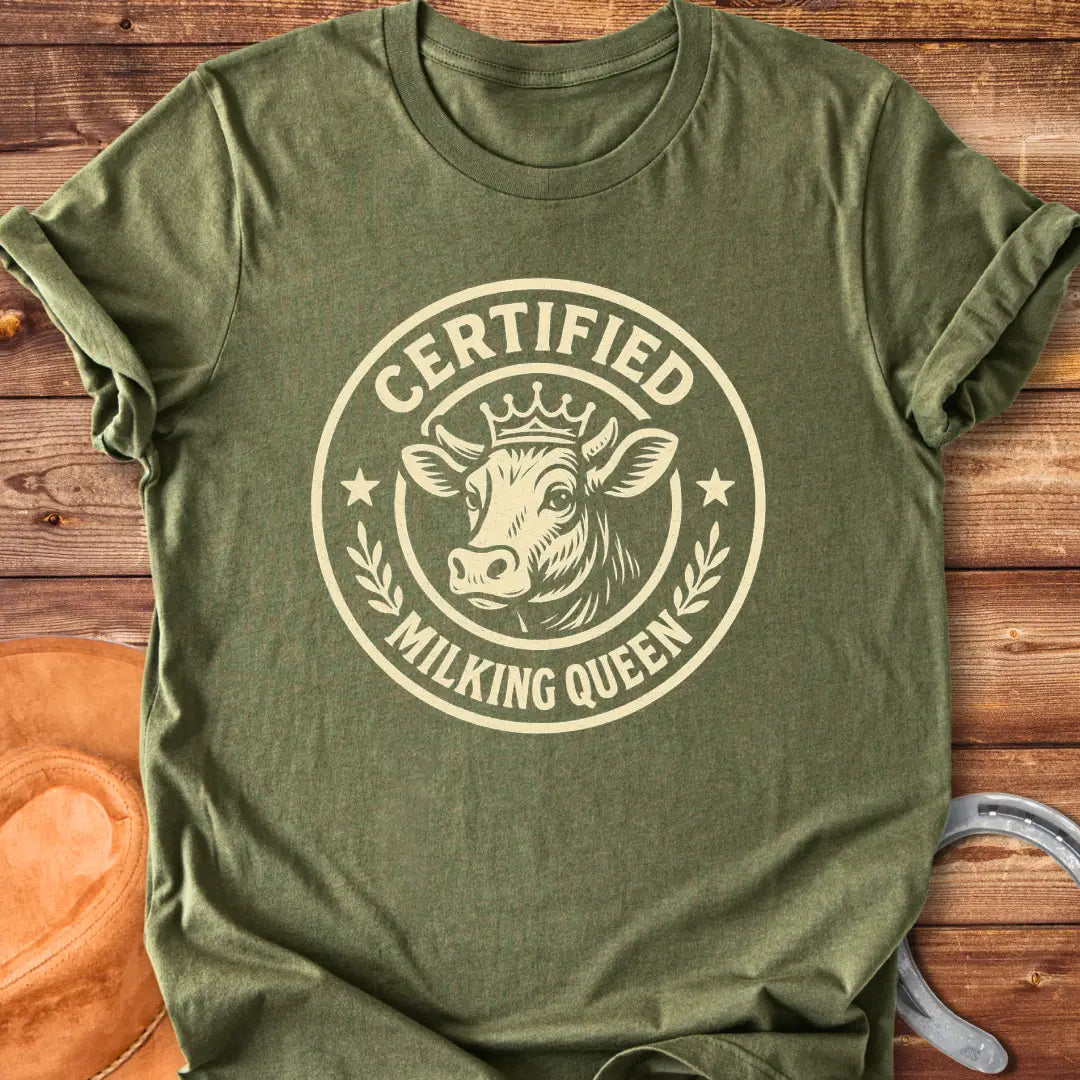 Certified Milking Queen T-Shirt design with a cow wearing a crown, and the words 'Certified Milking Queen' in a circular emblem.