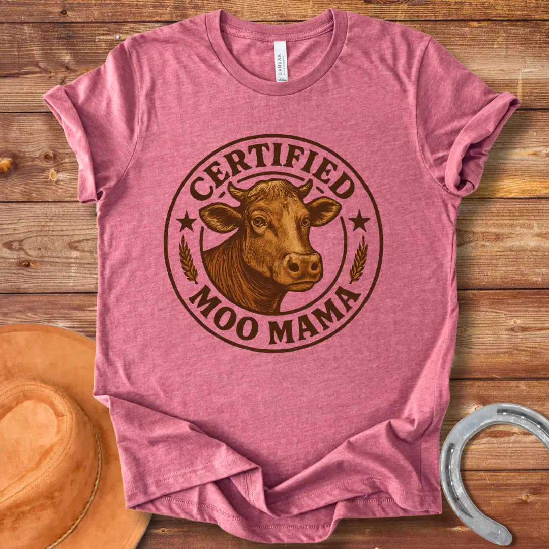 Certified Moo Mama T-shirt design with a detailed illustration of a cow's head inside a seal with the words 'Certified Moo Mama' around the edge.