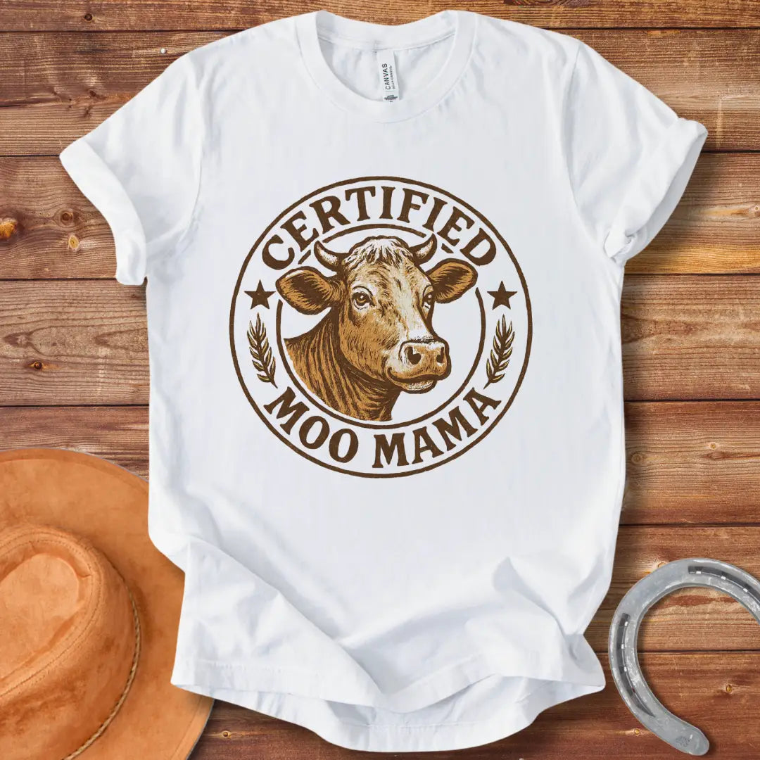 Certified Moo Mama T-shirt design with a detailed illustration of a cow's head inside a seal with the words 'Certified Moo Mama' around the edge.