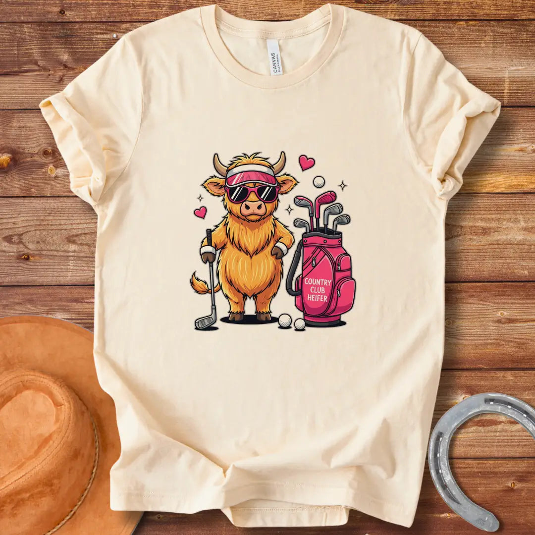 Cartoon illustration of a stylish Highland cow wearing sunglasses and a visor, holding a golf club next to a golf bag that reads 'Country Club Heifer.'