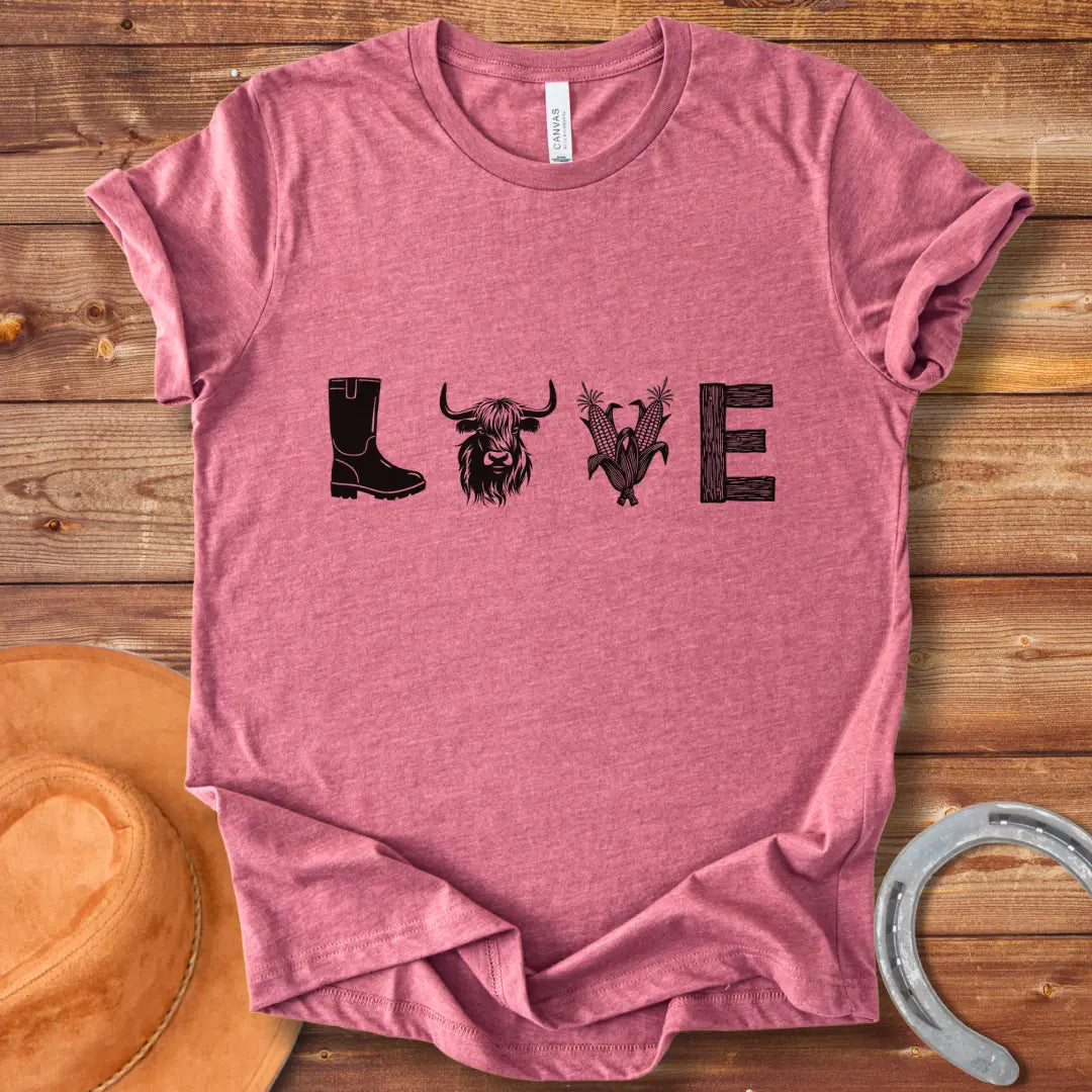 Cow Love T-Shirt featuring a design with the word 'LOVE' stylized with farm and plant imagery on a black background.
