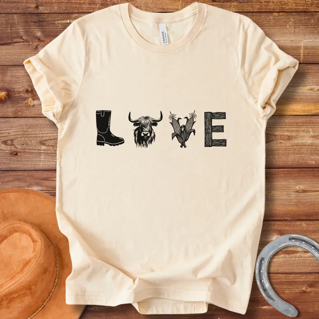 Cow Love T-Shirt featuring a design with the word 'LOVE' stylized with farm and plant imagery on a black background.