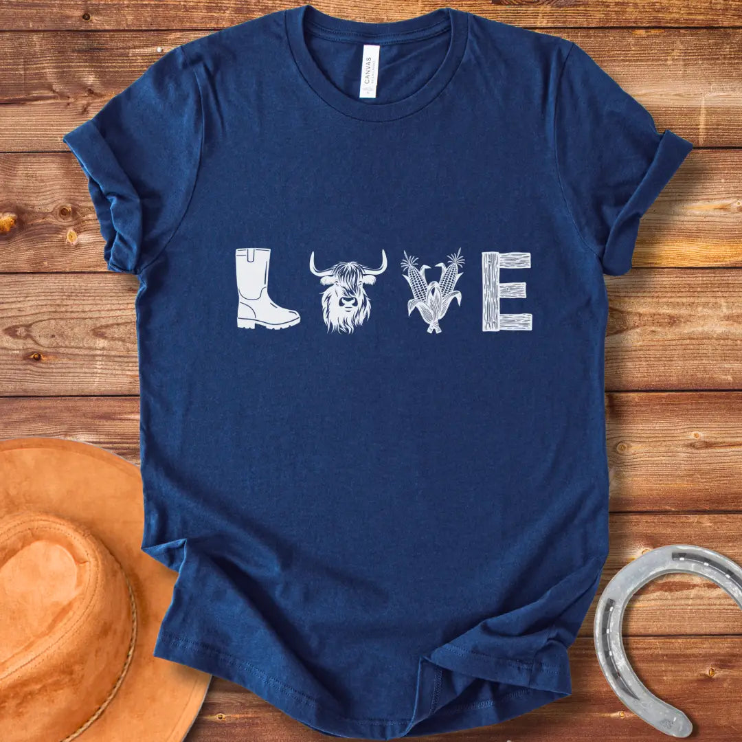 Cow Love T-Shirt featuring a design with the word 'LOVE' stylized with farm and plant imagery on a black background.