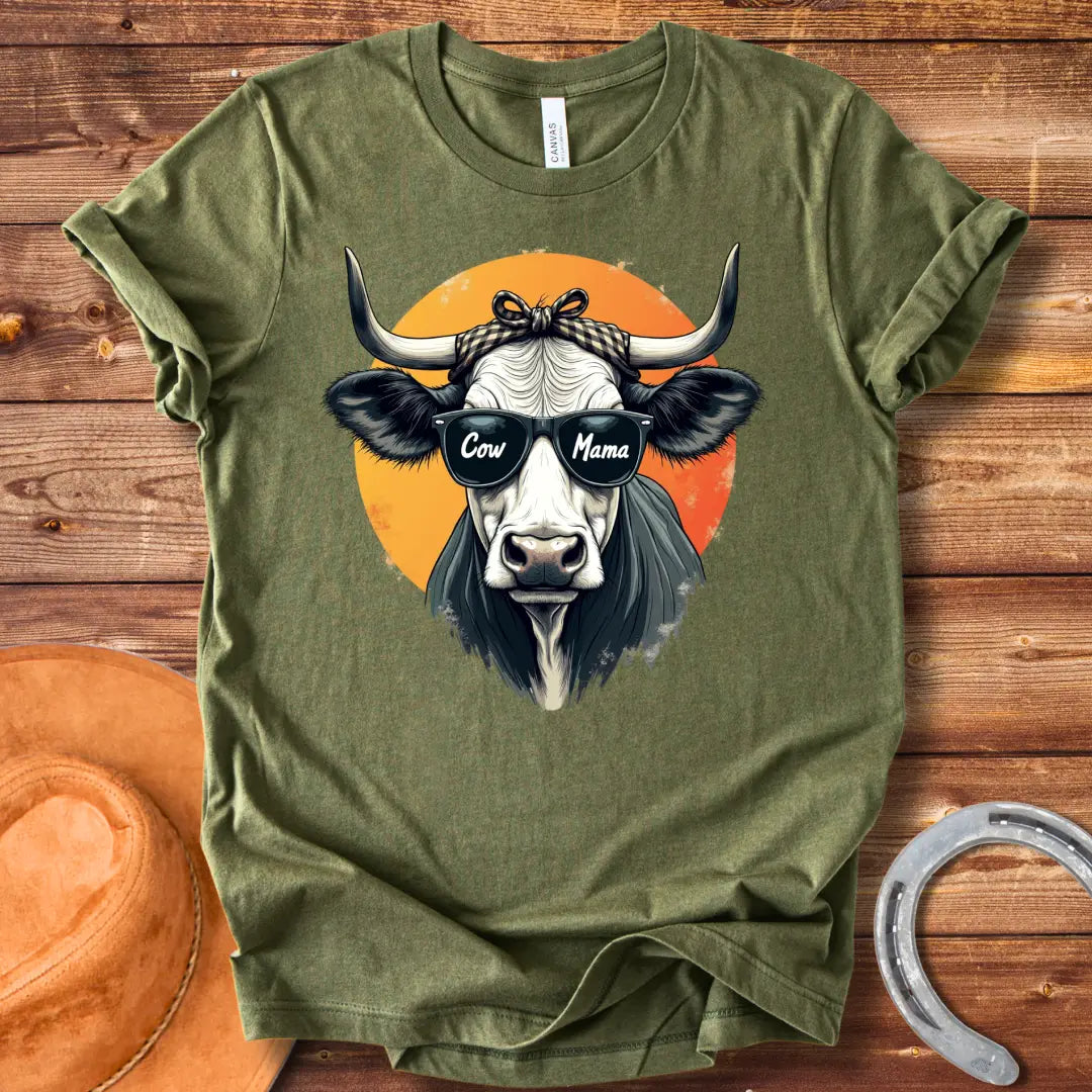Cow Mama T-Shirt featuring a cool cow wearing sunglasses that say 'Cow Mama', against an orange sun.