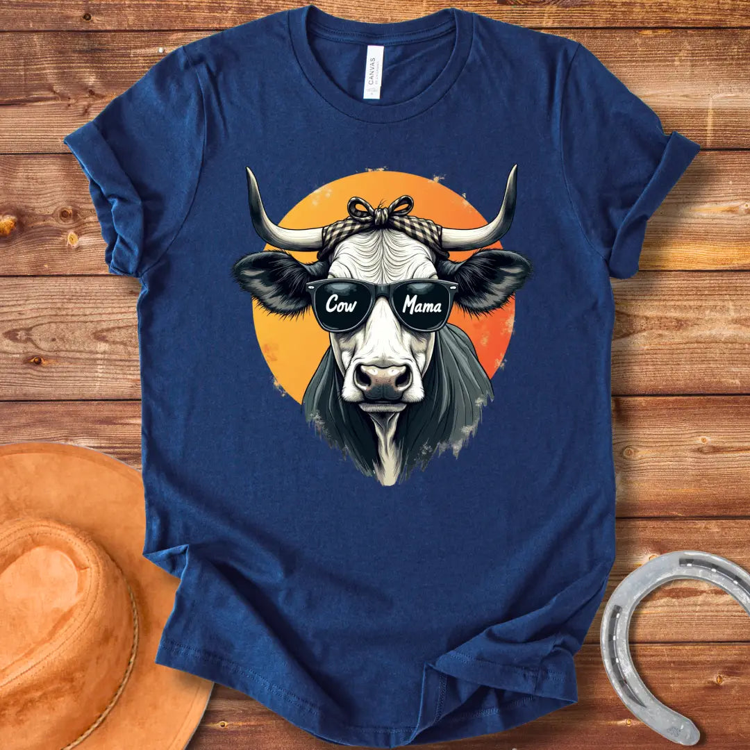 Cow Mama T-Shirt featuring a cool cow wearing sunglasses that say 'Cow Mama', against an orange sun.