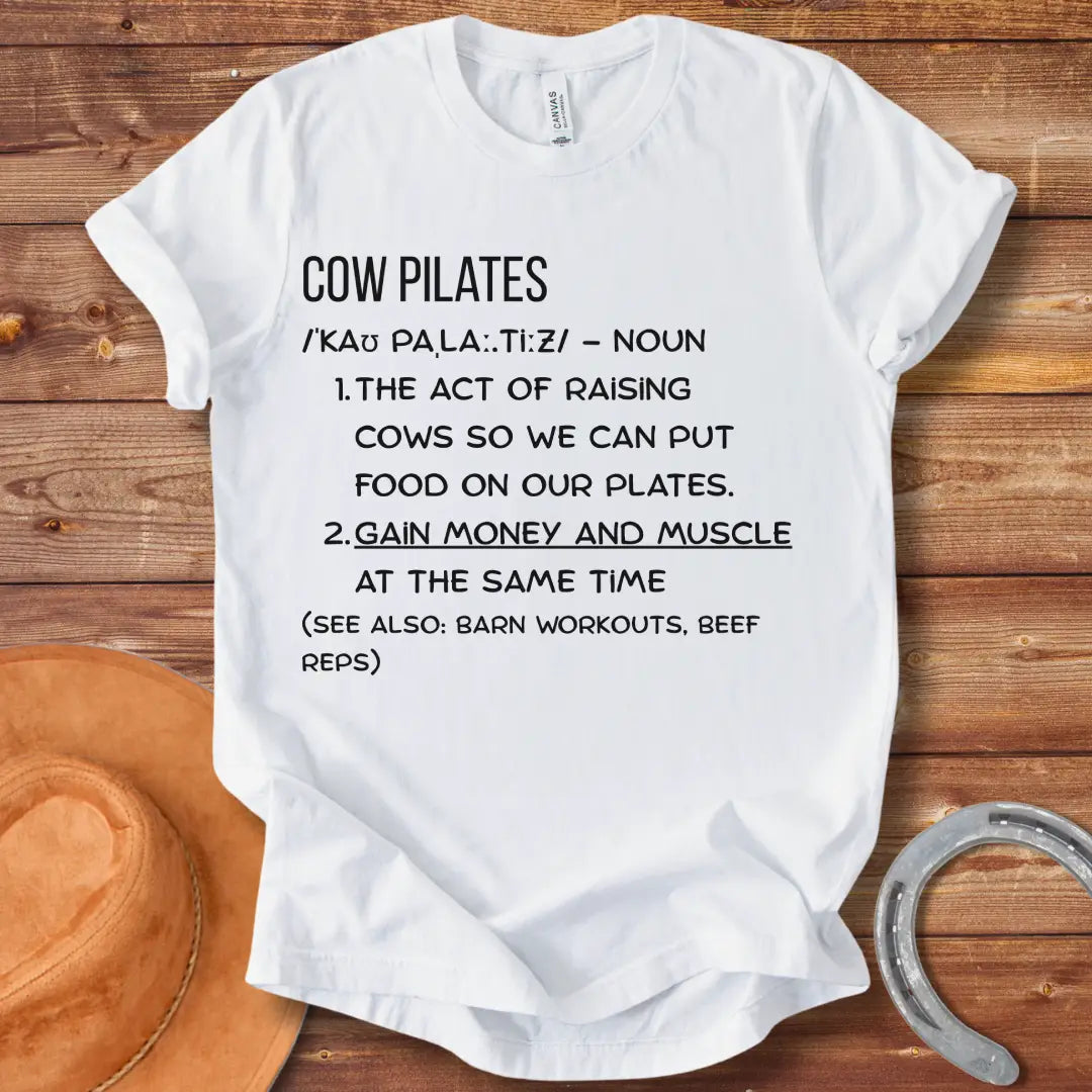 A stylish black t-shirt design featuring a cow doing pilates, against a black background.