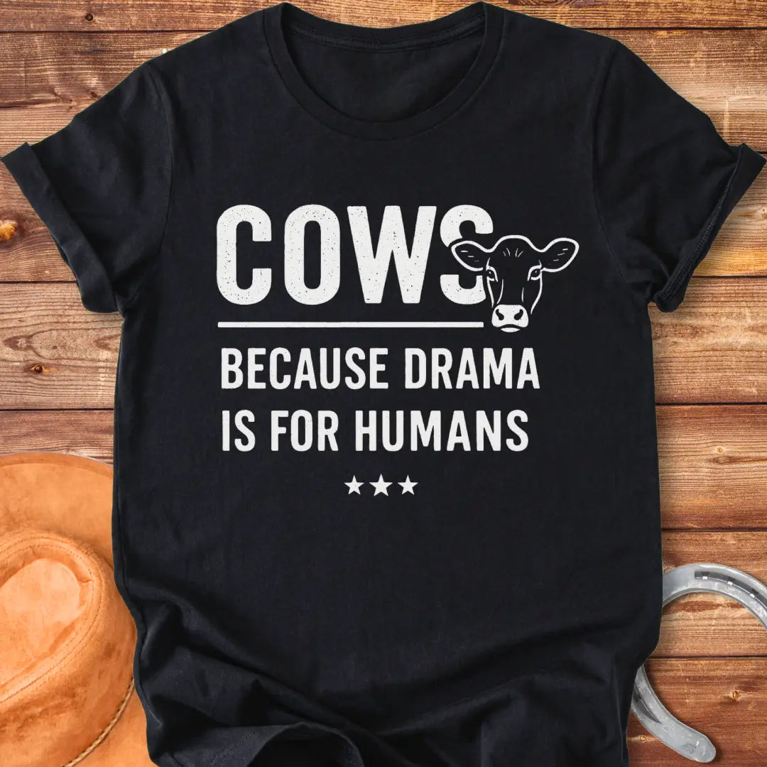 Black t-shirt design with the words 'Cows because drama is for humans' and a cow head illustration.