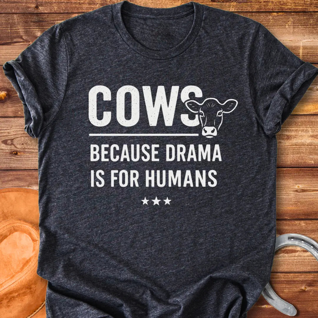 Black t-shirt design with the words 'Cows because drama is for humans' and a cow head illustration.