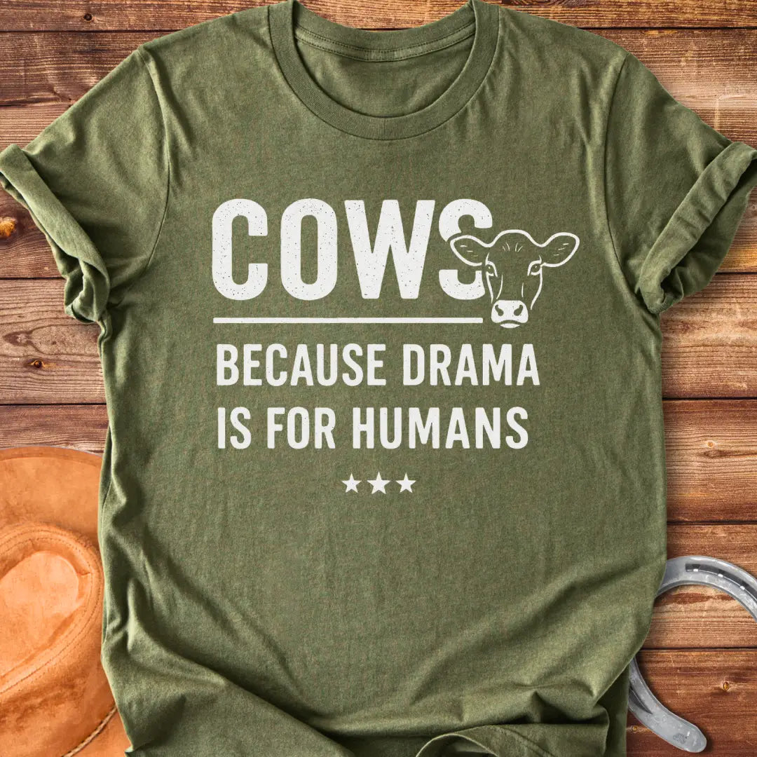 Black t-shirt design with the words 'Cows because drama is for humans' and a cow head illustration.