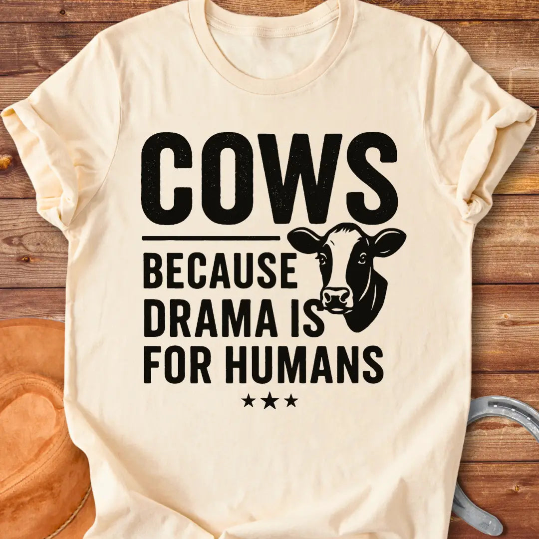 Black t-shirt design with the words 'Cows because drama is for humans' and a cow head illustration.