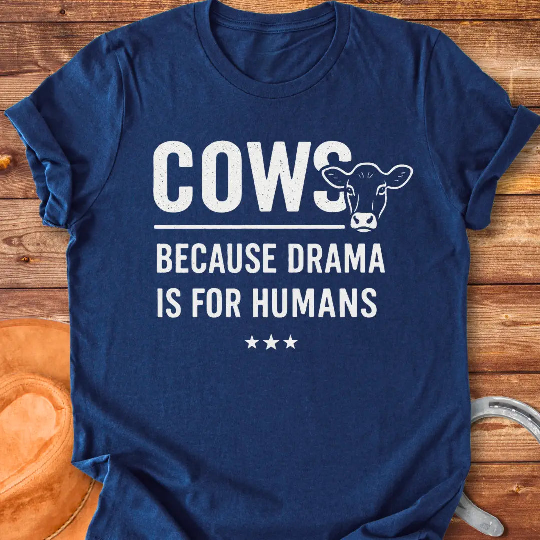 Black t-shirt design with the words 'Cows because drama is for humans' and a cow head illustration.