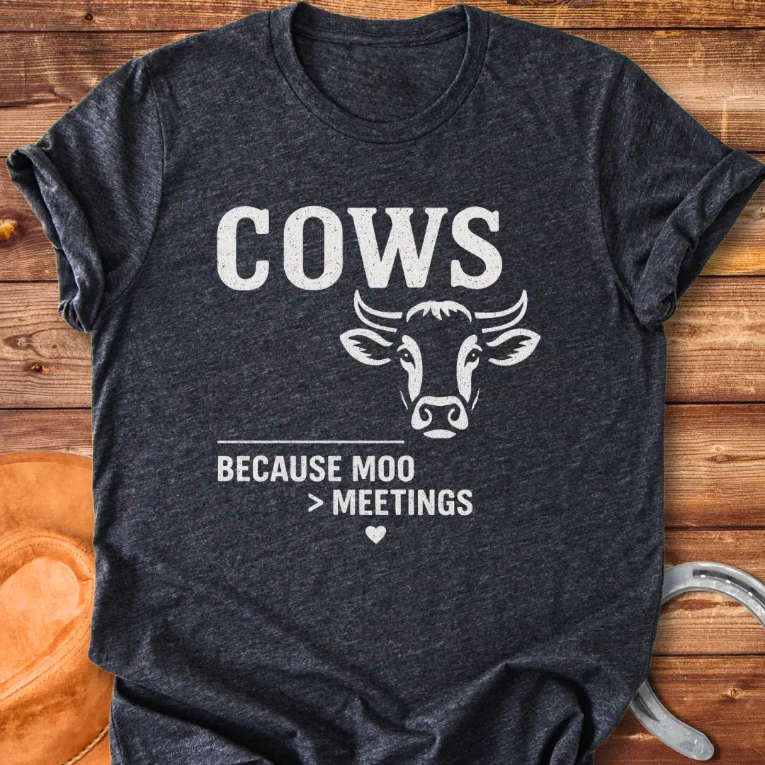 Black and white t-shirt design featuring a cow's face with the words Cows Because Moo Better Than Meetings