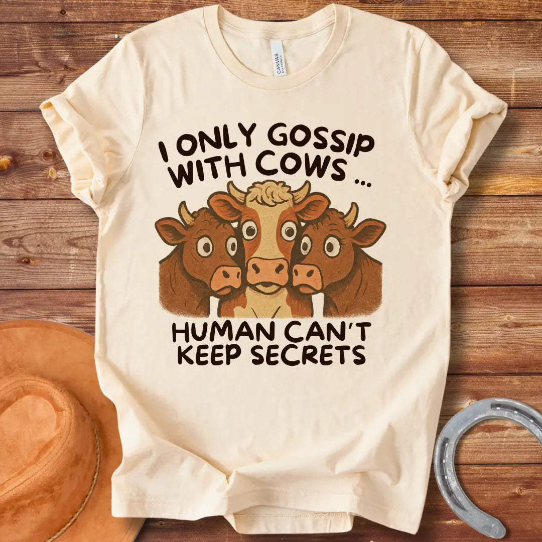 Illustration of three cows huddled together with the text "I Only Gossip With Cows... Humans Can't Keep Secrets".