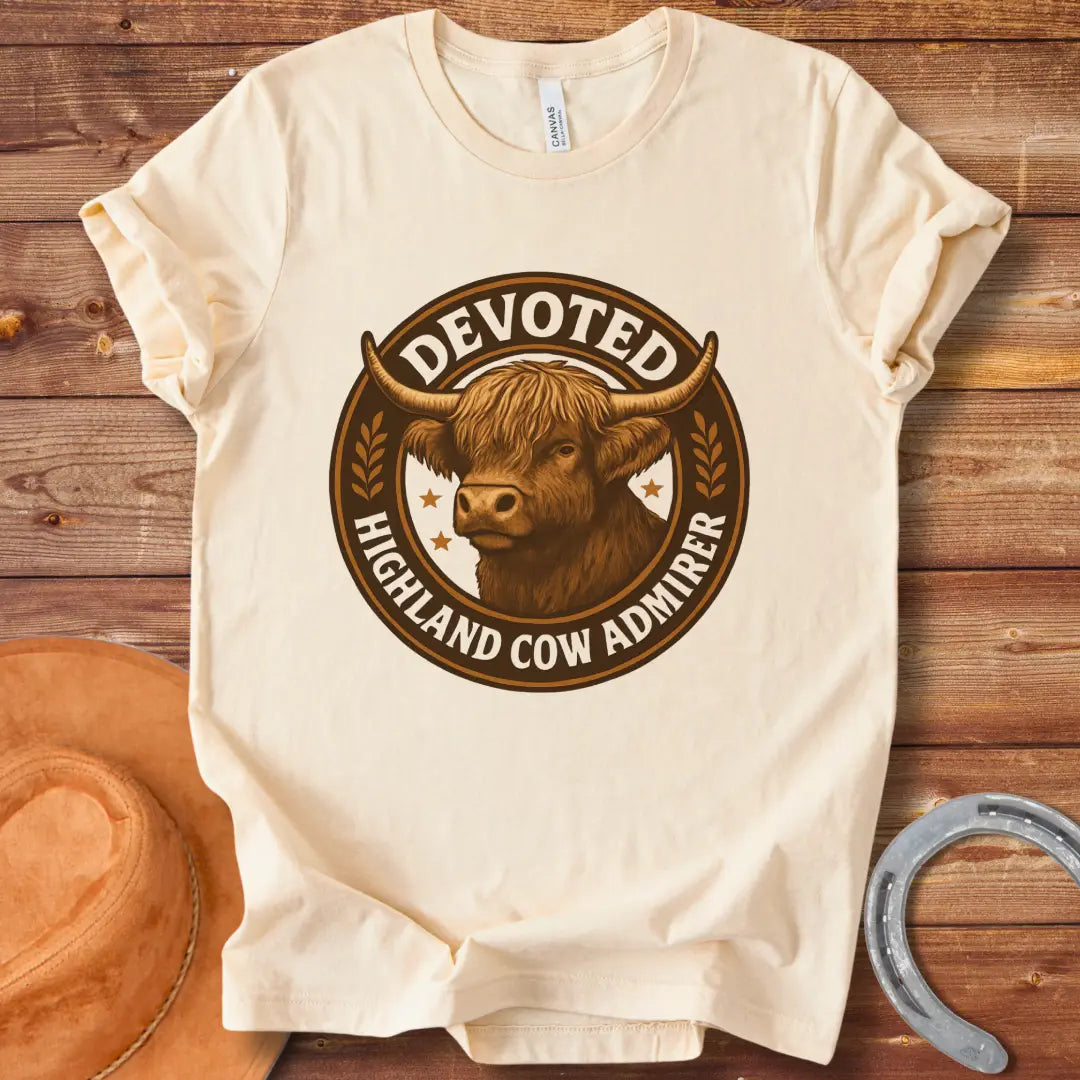 Devoted Highland Cow Admirer T-Shirt design featuring a detailed illustration of a Highland cow's head inside a circular frame with text.