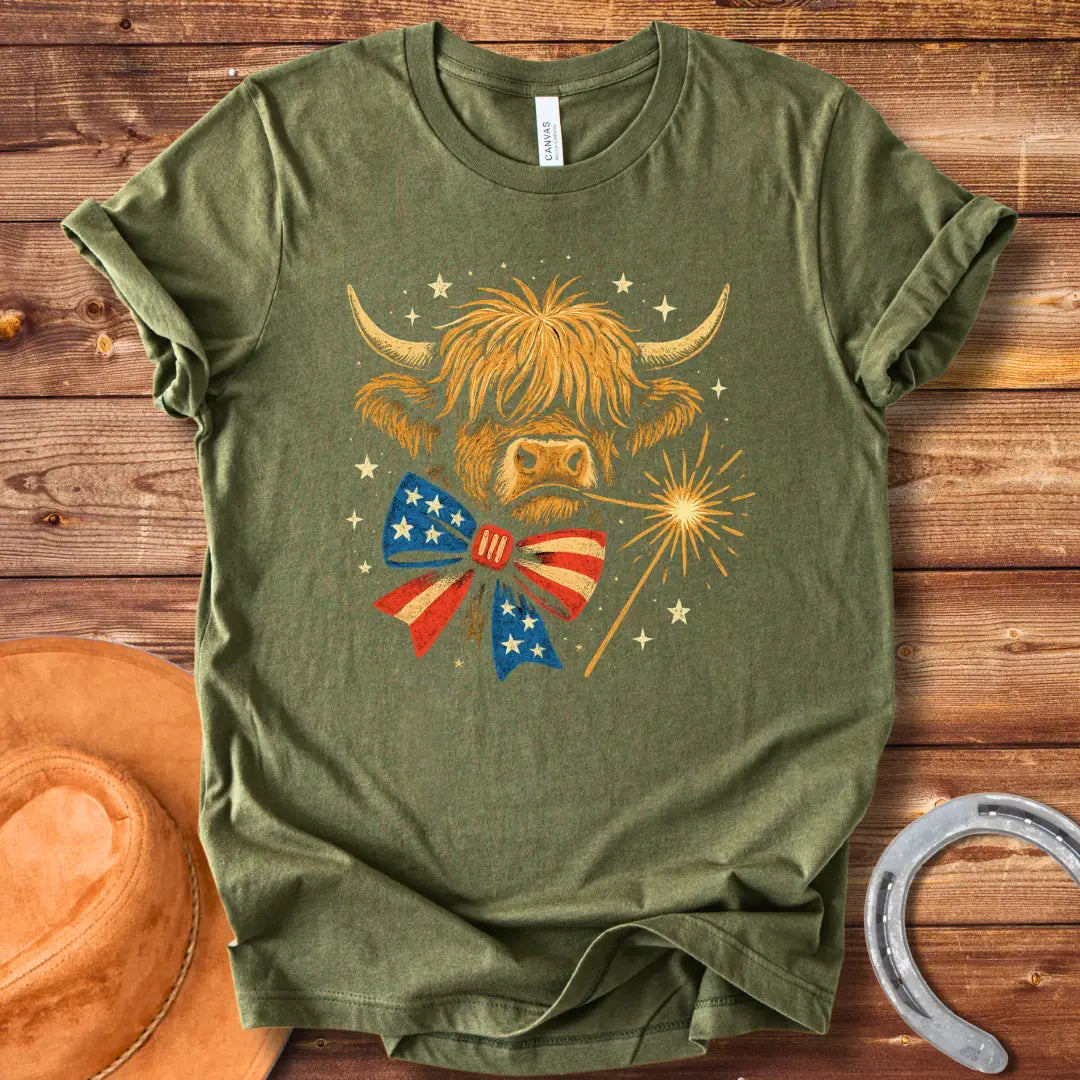 Festive patriotic Highland cow wearing a patriotic bow tie holding a sparkler.