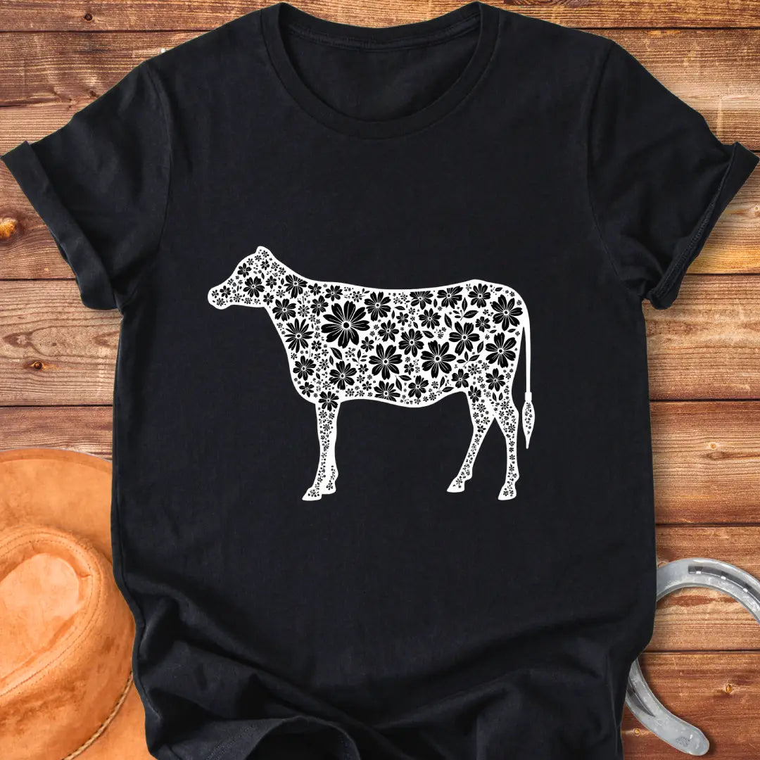 Floral cow t-shirt featuring a cow silhouette filled with white floral elements on a black background