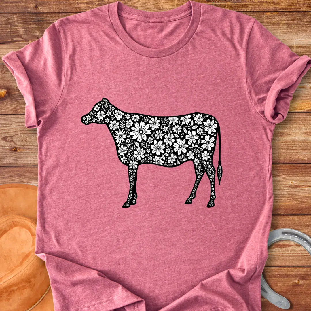 Floral cow t-shirt featuring a cow silhouette filled with white floral elements on a black background
