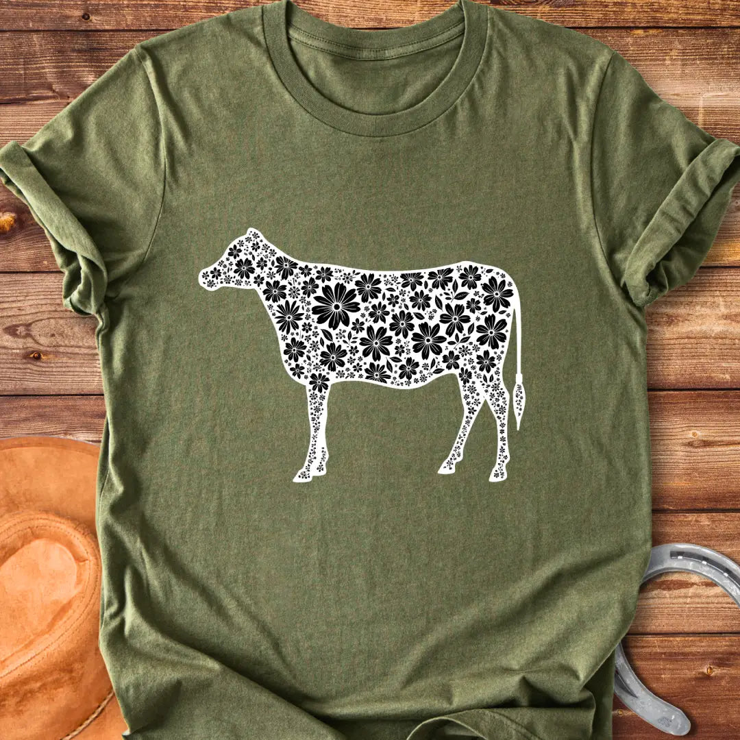 Floral cow t-shirt featuring a cow silhouette filled with white floral elements on a black background