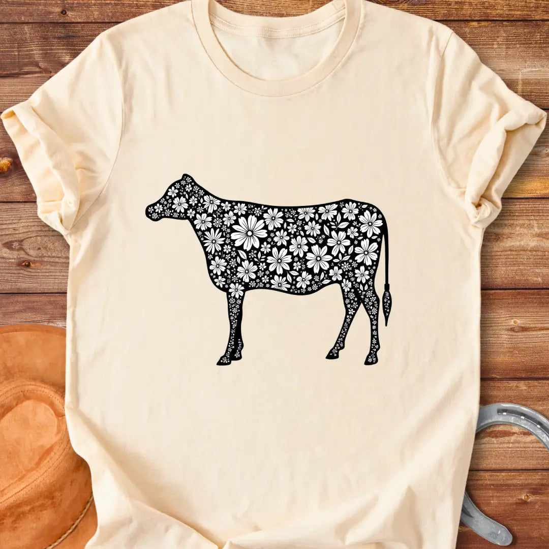 Floral cow t-shirt featuring a cow silhouette filled with white floral elements on a black background