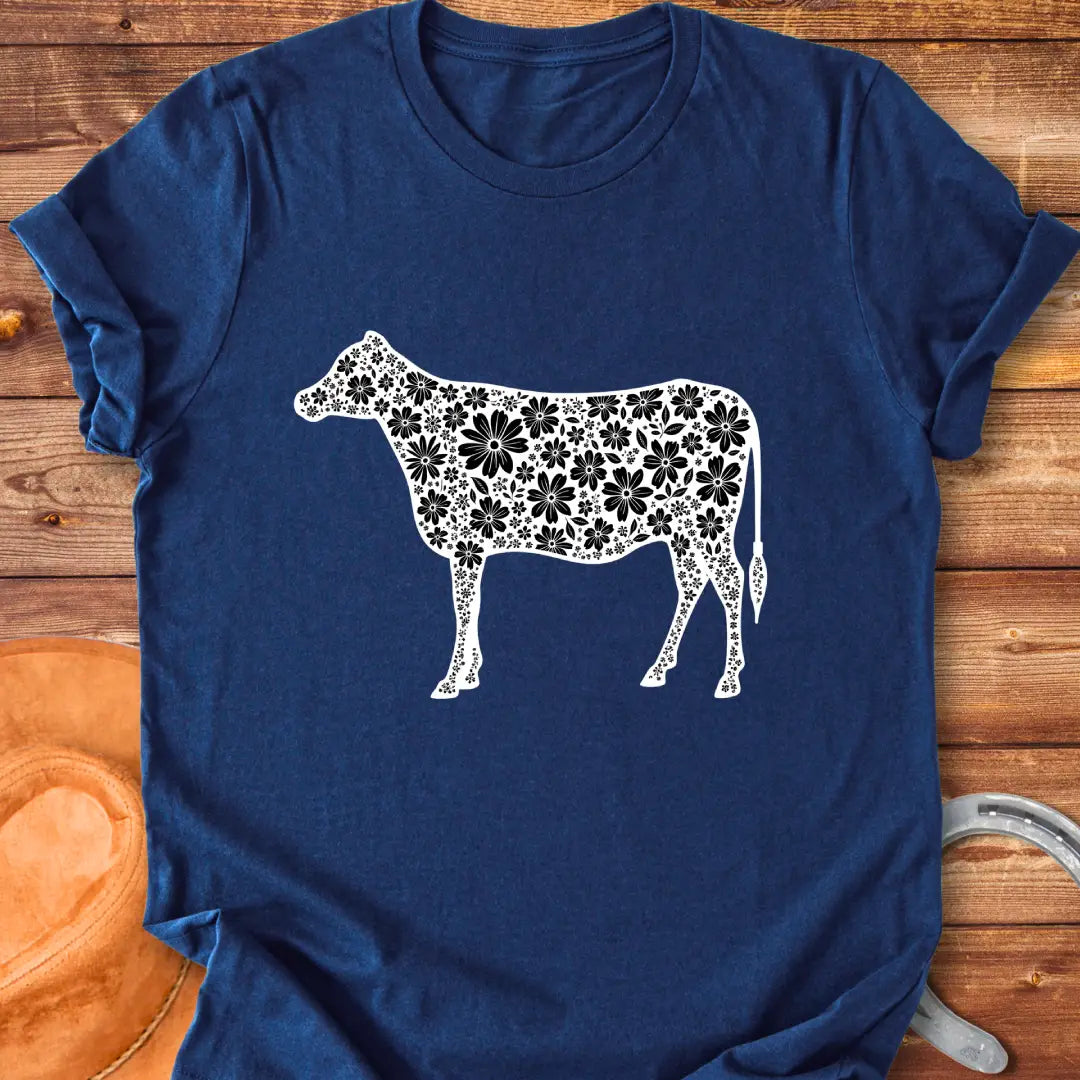 Floral cow t-shirt featuring a cow silhouette filled with white floral elements on a black background