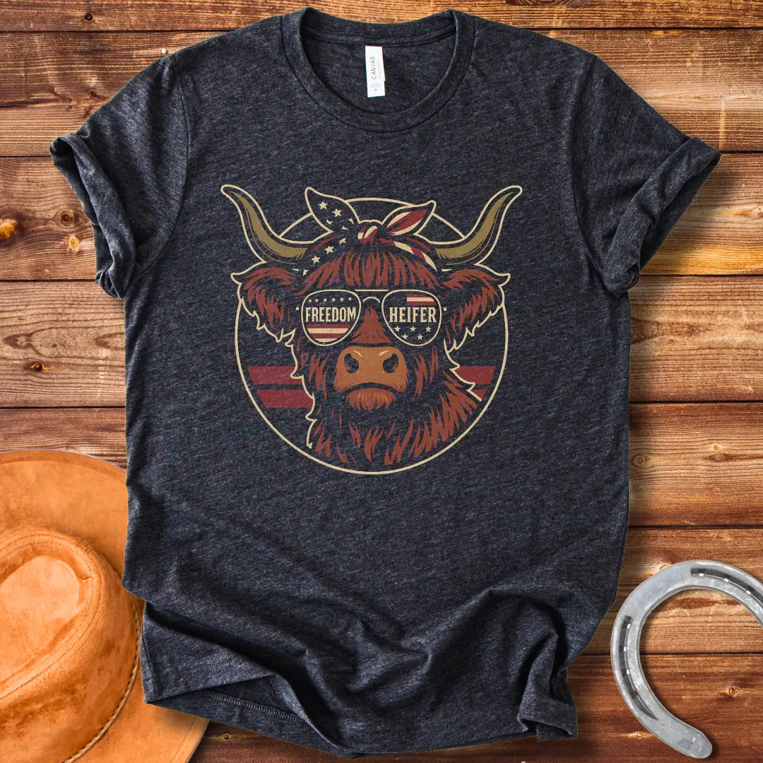 Freedom Heifer T-Shirt: Highland cow wearing sunglasses with the American flag design.