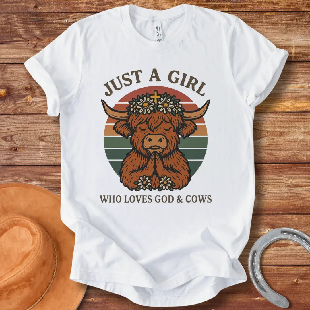 A praying Highland cow wearing a daisy crown with a cross, set against a retro sunset graphic. Text reads: 'Just a girl who loves God & Cows'.