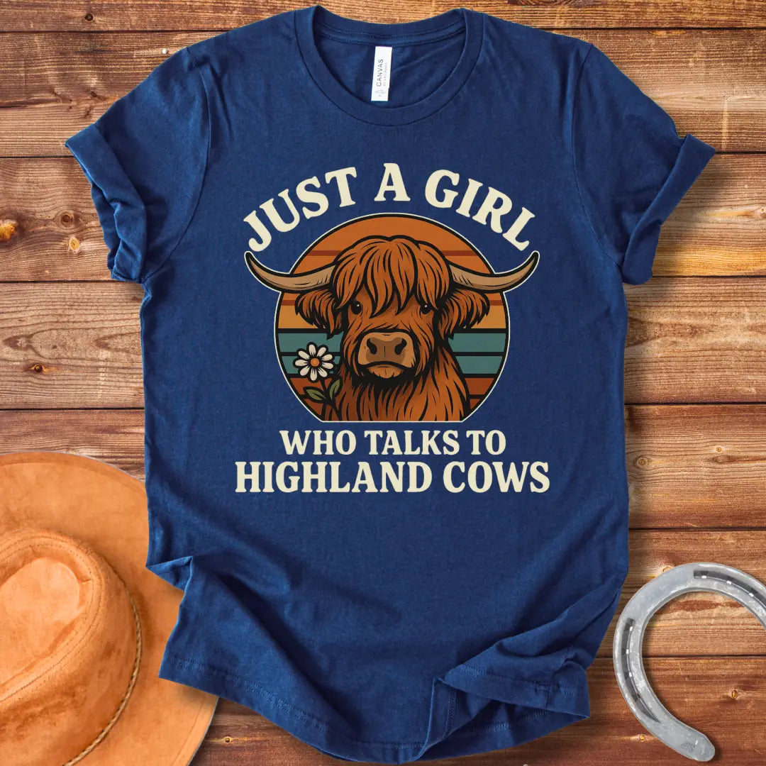 T-shirt featuring a cute Highland cow graphic with the text 'Just a Girl Who Talks to Highland Cows' and a flower.