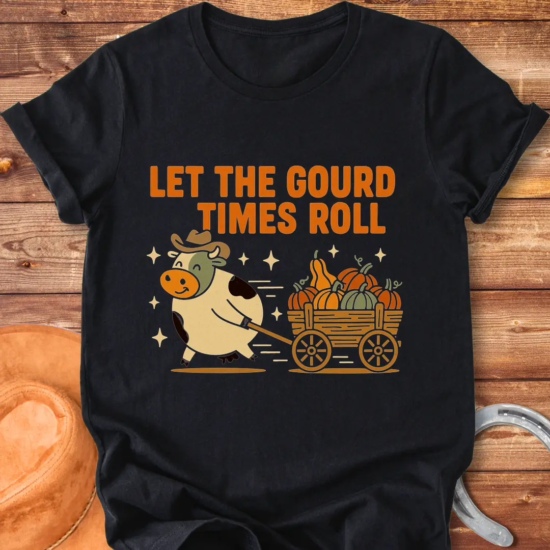 Cow pulling a wagon full of pumpkins with the text 'Let the Gourd Times Roll' – a fall-themed t-shirt design from Cow Lovers Clothing.